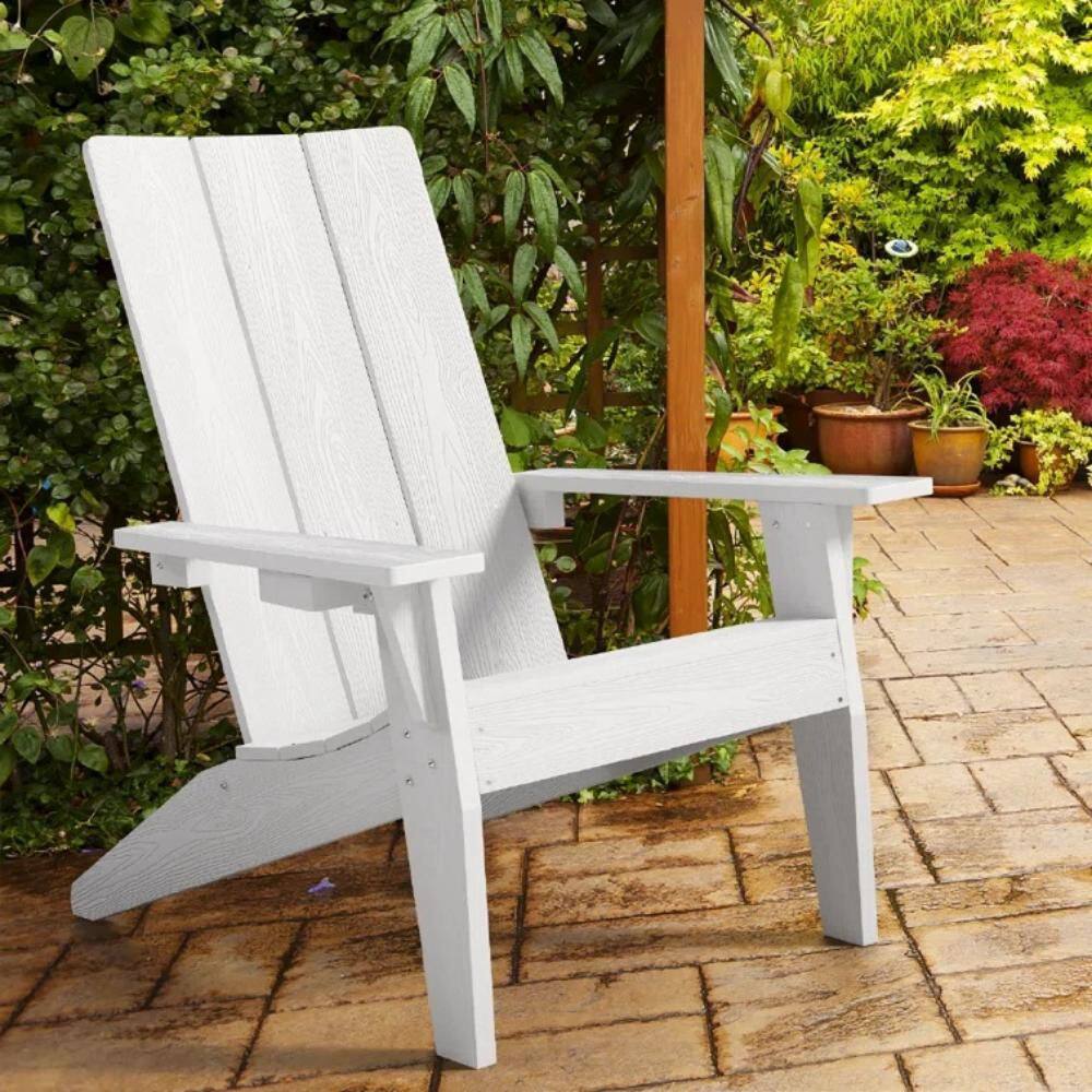White Adirondack chair in a garden setting