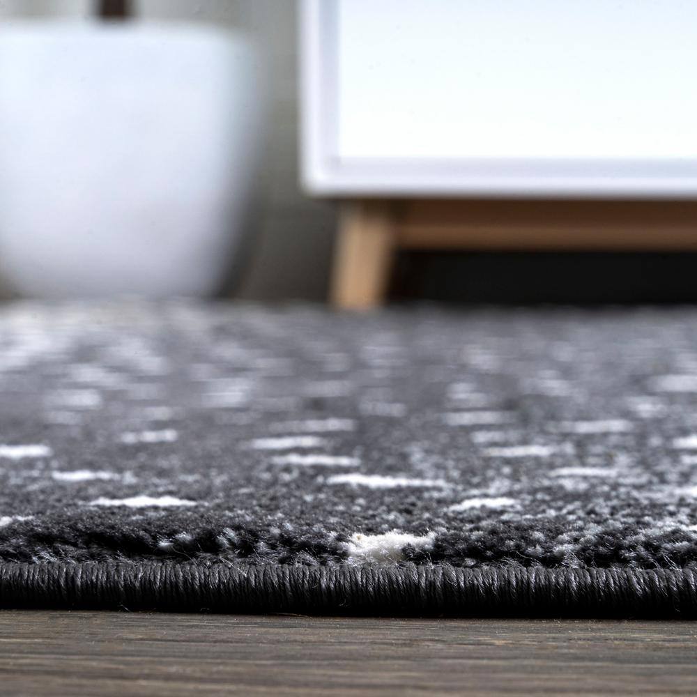 Abstract Antelope 8' x 10' Black and Ivory Synthetic Area Rug