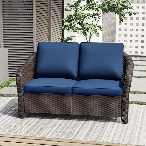 Dark Brown Wicker Outdoor Loveseat with Stylish Curved Arms and Plush Blue Cushions