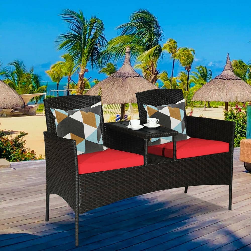 Compact Black Wicker Patio Loveseat with Red Cushions and Glass Table