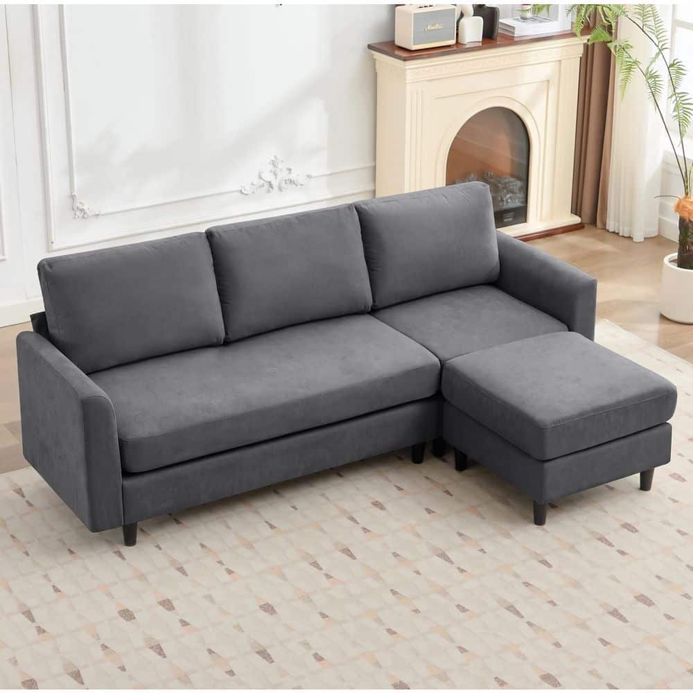 Dark gray clinquant velvet sectional sofa with a chaise lounge.