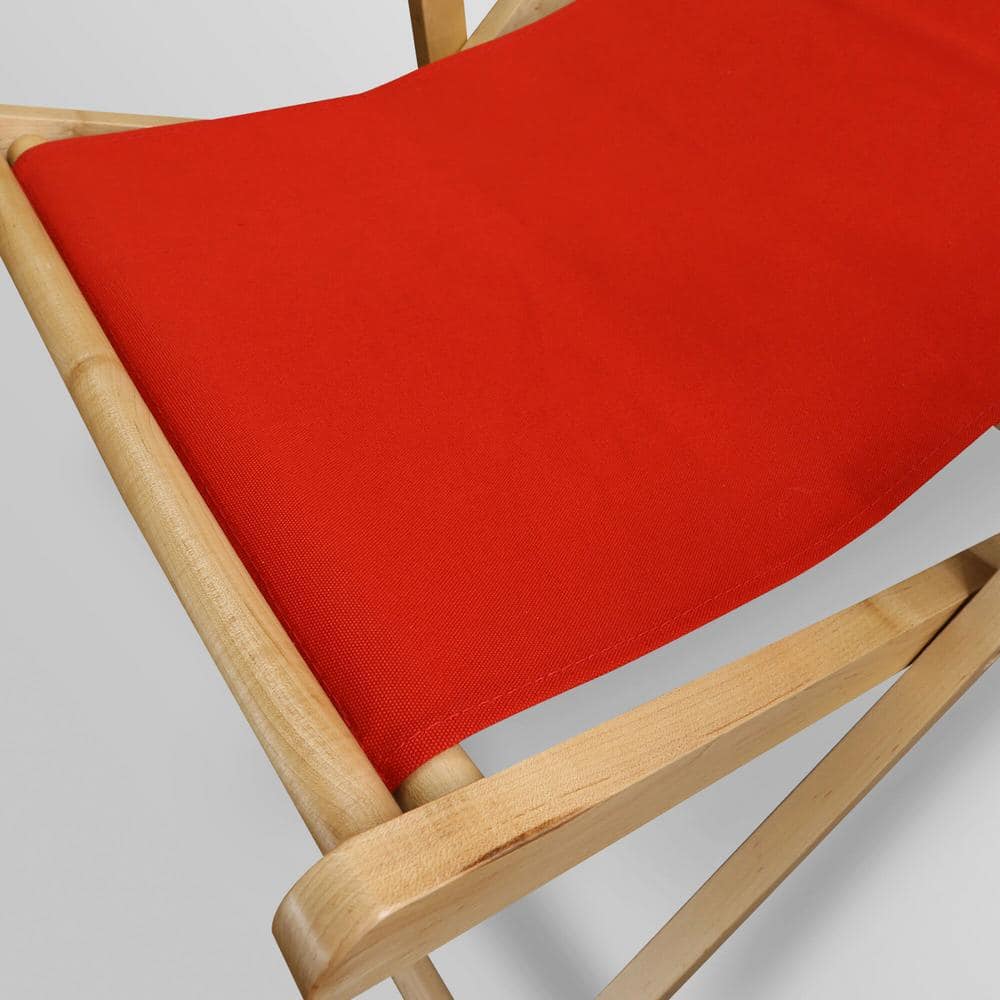 Close-up of the red canvas fabric on a wooden sling chair.