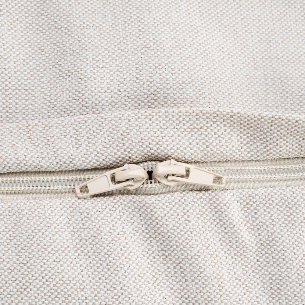 Close-up of a beige zipper on the bean bag chair.