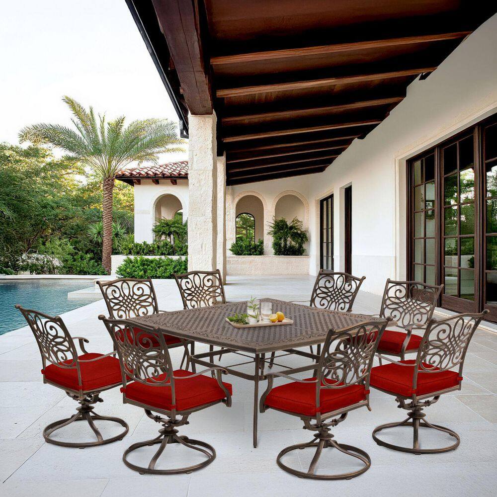 9-piece Traditions outdoor dining set on a patio overlooking a pool and ocean.