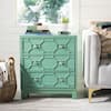 Green nightstand chest in a styled bedroom setting.