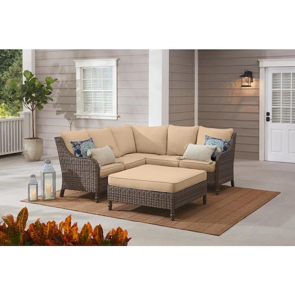 Hampton Bay Windsor 4-Piece Brown Wicker Outdoor Patio Sectional Sofa with Ottoman and Sunbrella Beige Tan Cushions