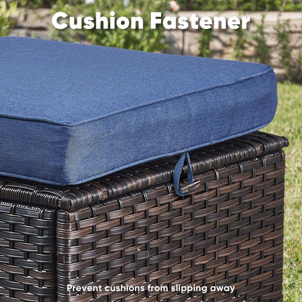 Cushion fastener securing a blue cushion to a wicker ottoman.