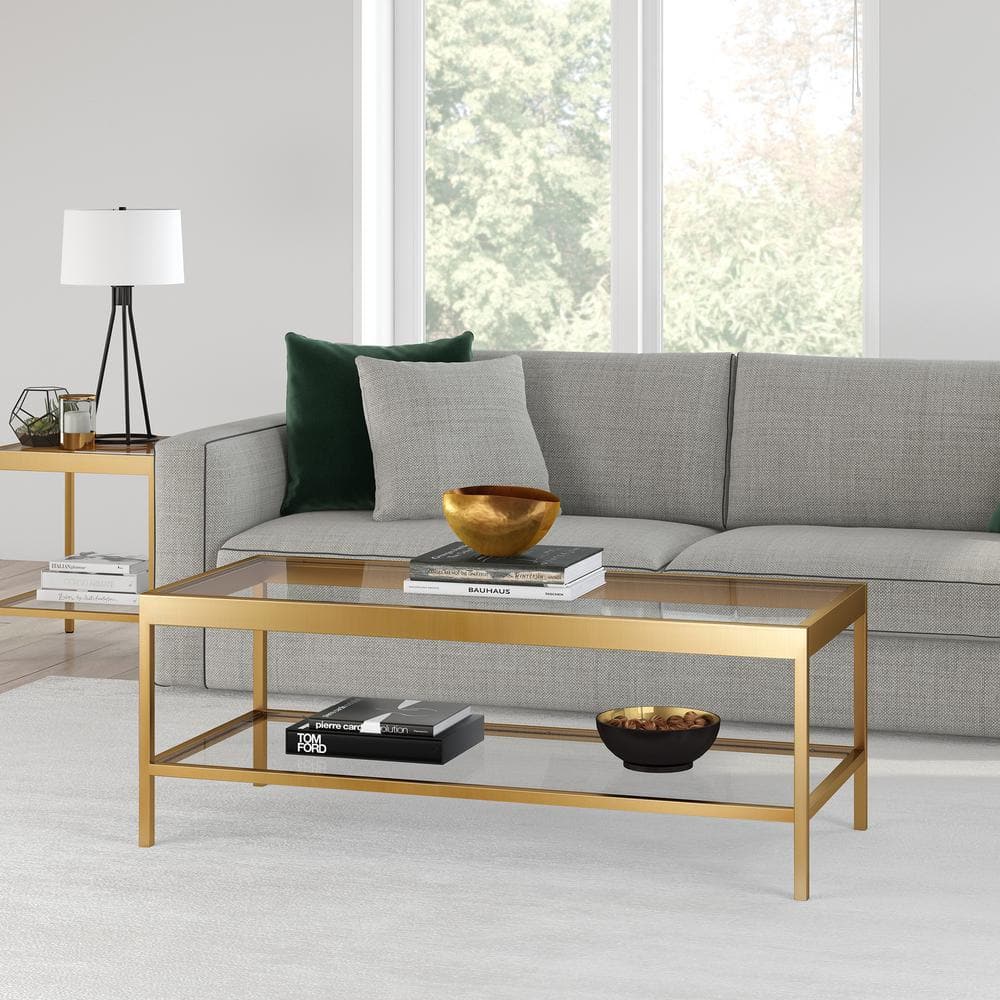 Alexis 45 In. Brass Rectangle Glass Top Coffee Table in a living room setting