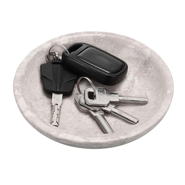 A 5.5-inch travertine key gray bowl for organizing jewelry and trinkets on entryways.