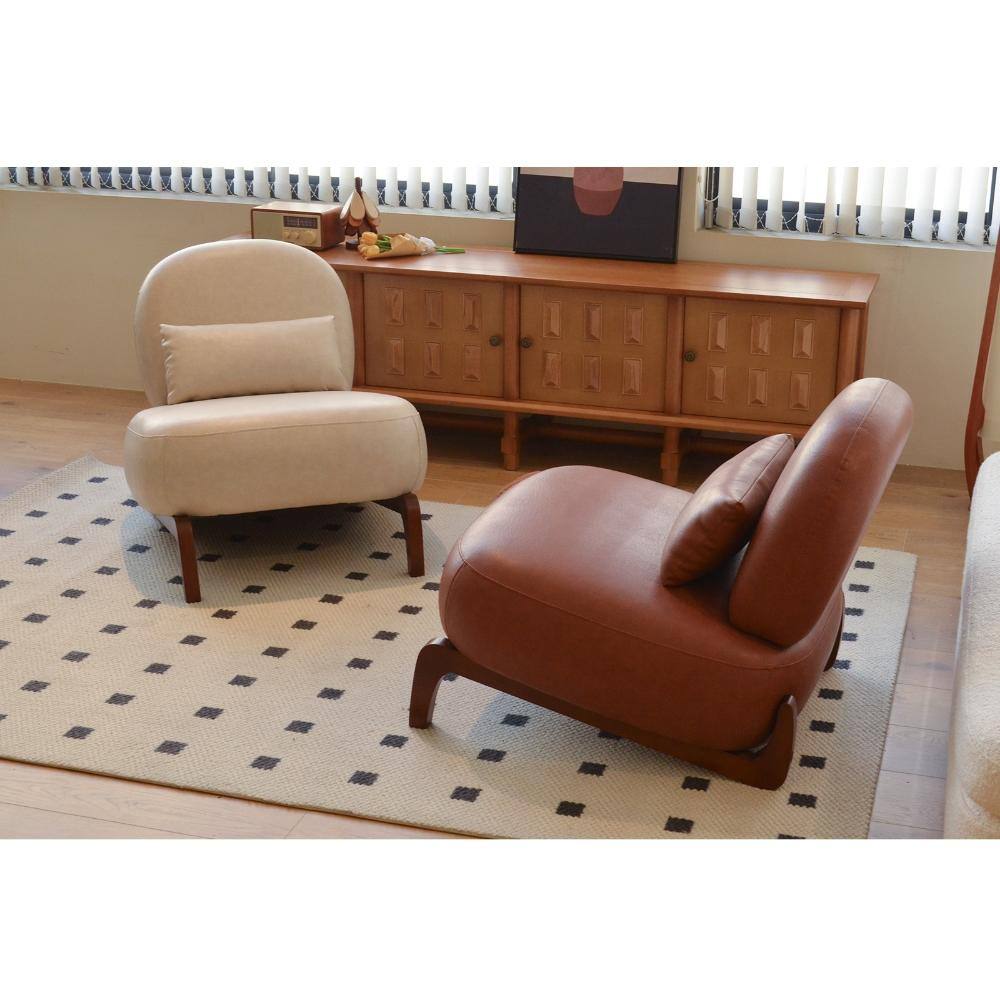 Two armless accent chairs, one cream and one brown, side-by-side in a room.