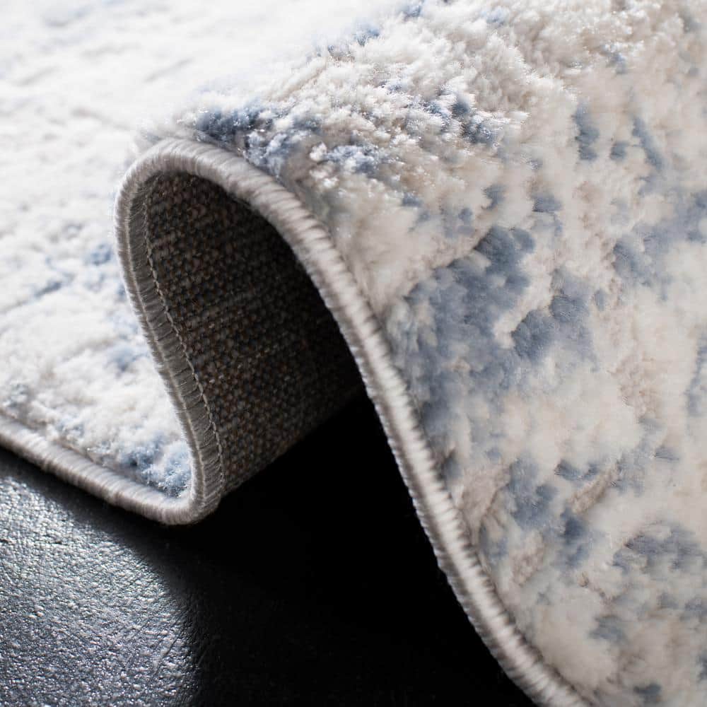 Ivory and Blue Abstract 8' x 10' Synthetic Area Rug