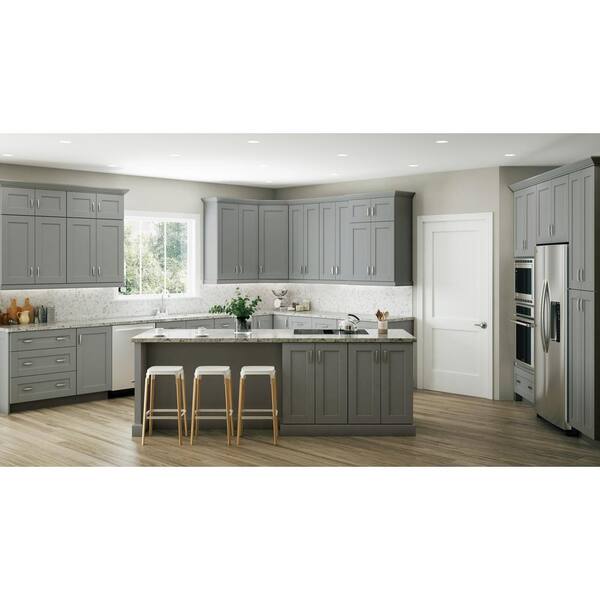 Grey kitchen cabinets against sage green walls in an attic