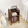 A mobile record player stand in a living room setting with a turntable on top.