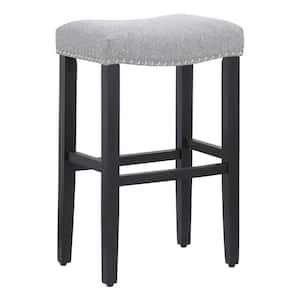 Jameson 29 in. Bar Height Black Wood Backless Nailhead Trim Barstool with Upholstered Gray Linen Saddle Seat Stool