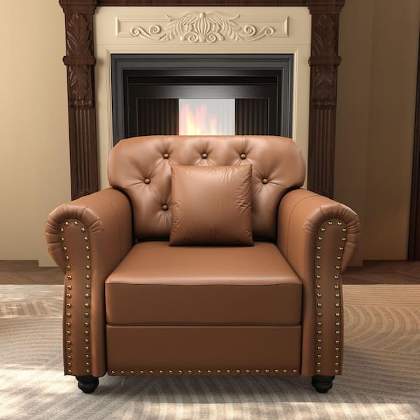 Brown faux leather armchair with nailhead trim in a living room setting.