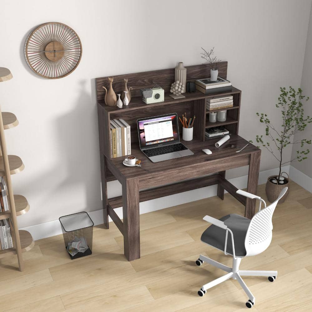 Wooden computer desk with a laptop and a white rolling chair.