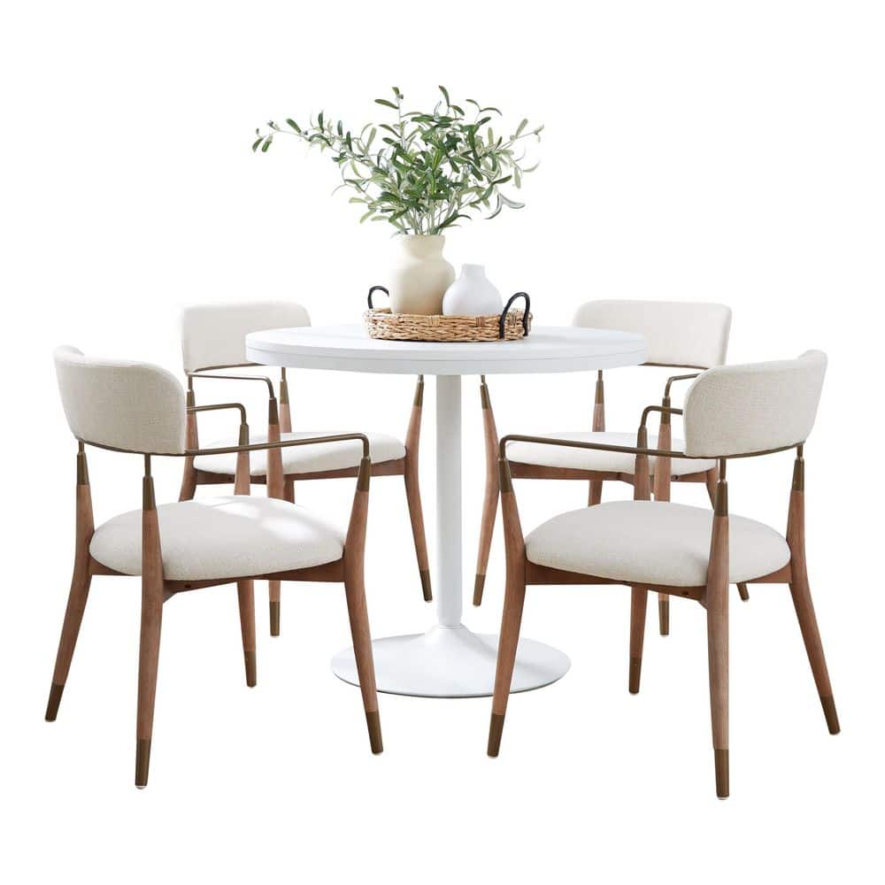 5-piece dining set with a white pedestal table and four cream upholstered chairs with whitewashed wood and copper metal legs.