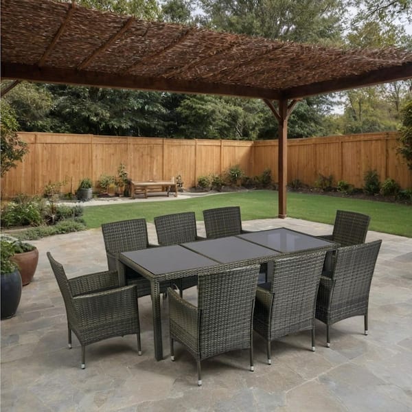 9-Piece Wicker Outdoor Dining Set with Black Cushions and Glass Tabletop