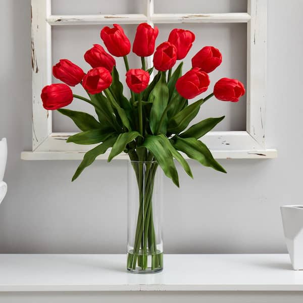 Red artificial store flowers in vase