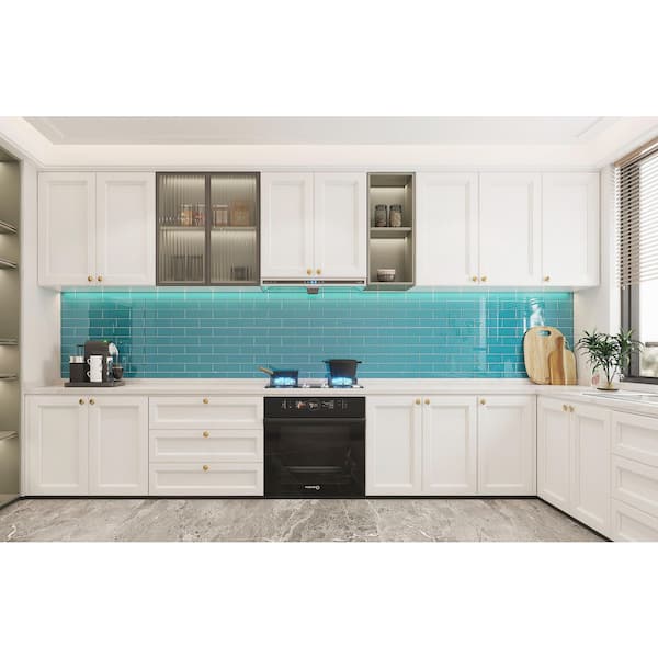 a bright kitchen with teal cabinets, mismatching tile backsplash