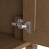 Close-up of a cabinet hinge and metal hardware.