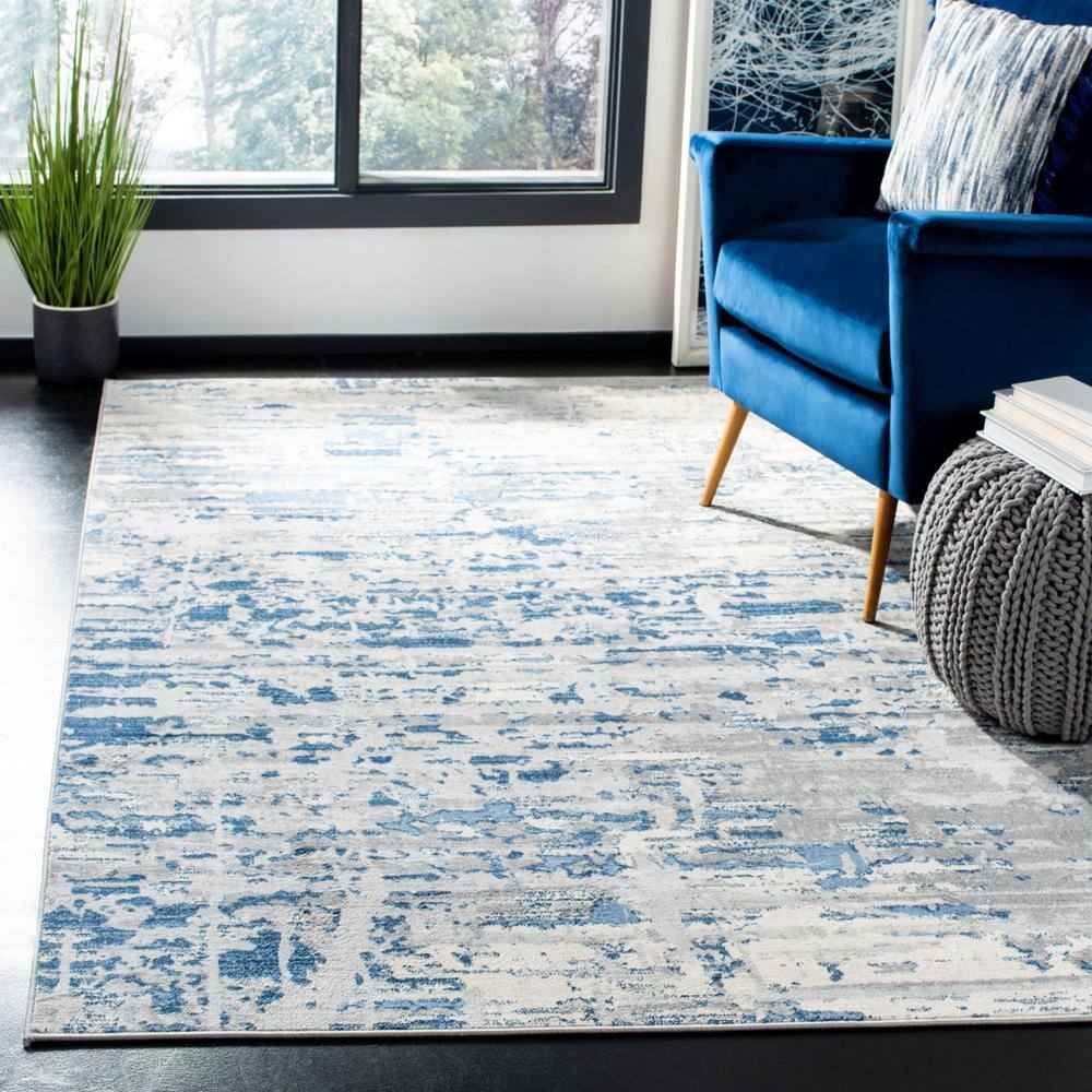 Ivory/Blue Abstract Synthetic 8' x 10' Easy Care Area Rug