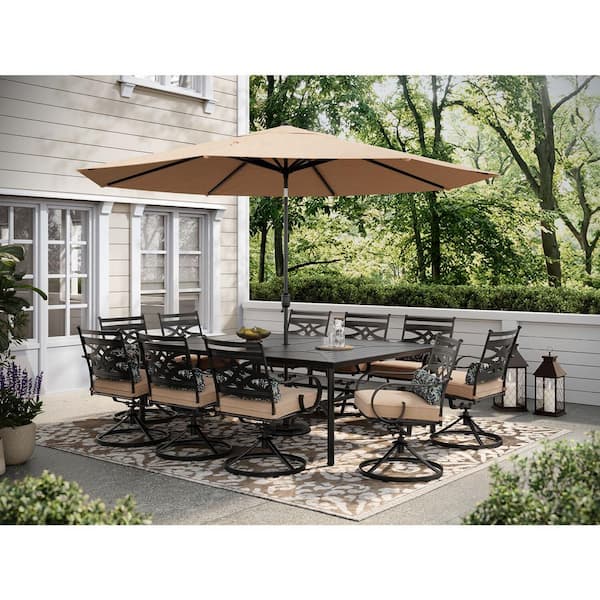 Hanover Montclair 11-Piece Steel Outdoor Dining Set with Tan Cushions, 10 Swivel Rockers, 60 in. x 84 in. Table and Umbrella