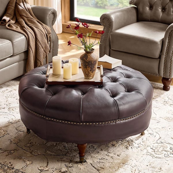 Geofredo Espresso Leather Round Ottoman with Tufted Top Nailhead Trim