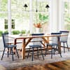 Dining room setting with wooden table and blue Windsor chairs under a chandelier.