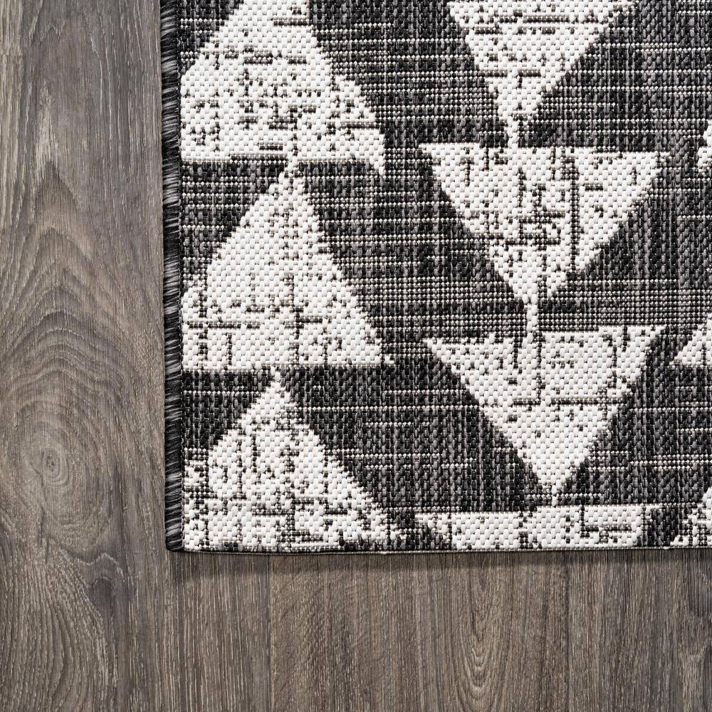 5' x 8' Black and Ivory Geometric Synthetic Area Rug