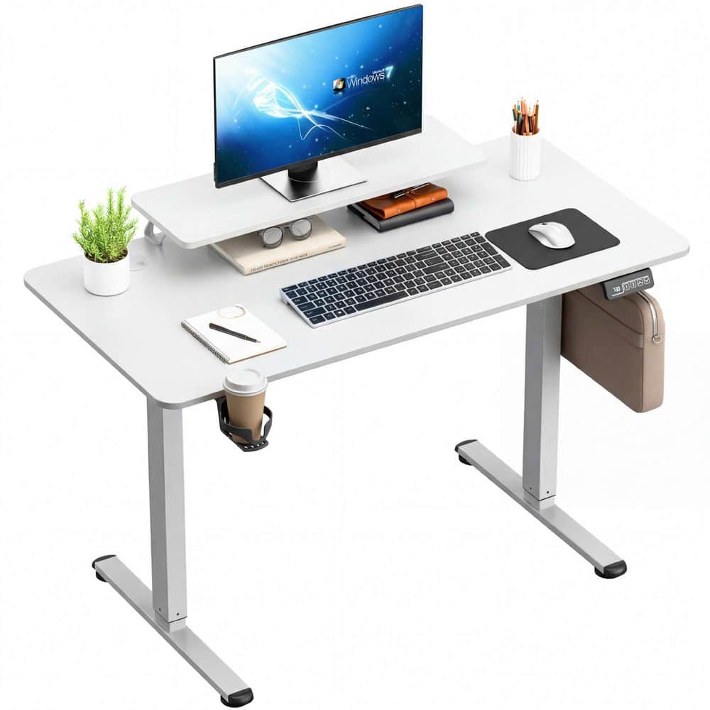 White rectangular electric standing desk with monitor stand and cup holder.