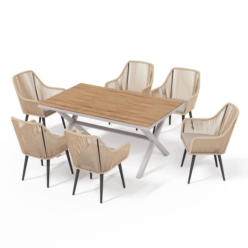 Six rattan dining chairs and a rectangular wooden table with beige cushions.