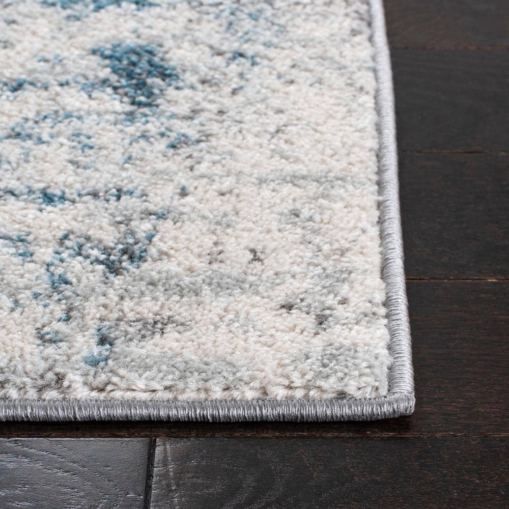 Ivory and Blue Abstract 9' x 12' Synthetic Area Rug