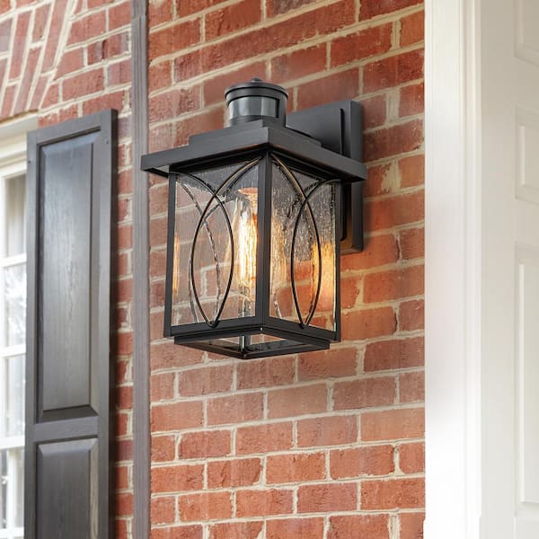 EDISLIVE Douglas 1-Light Black Outdoor Motion Sensor Dusk to Dawn Wall Sconce with Seeded Glass