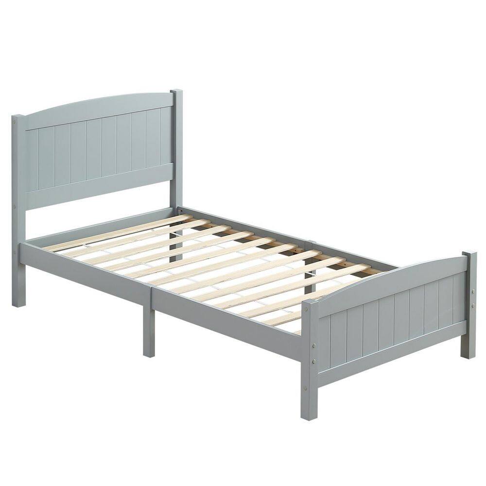 Three-quarter view of a gray pine wood twin platform bed without a mattress.