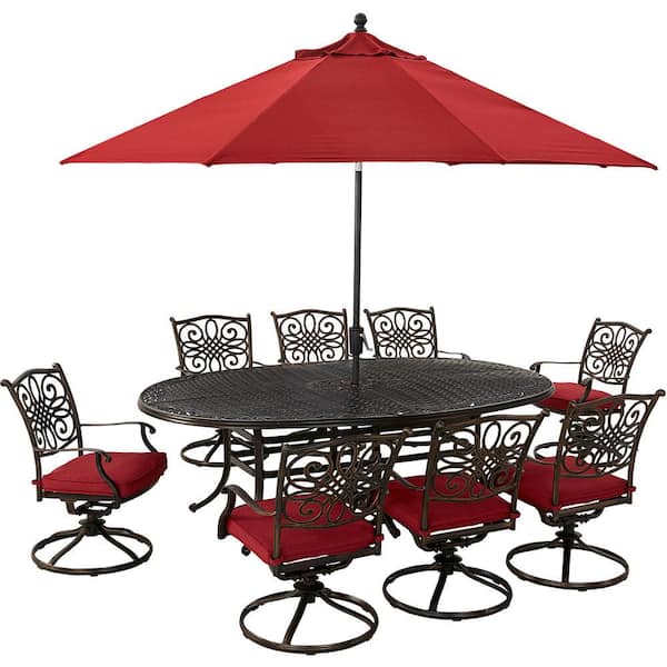 Hanover Traditions 9-Piece Aluminum Outdoor Dining Set with Red Cushions, 8 Swivel Rockers, Cast-Top Table, Umbrella and Base