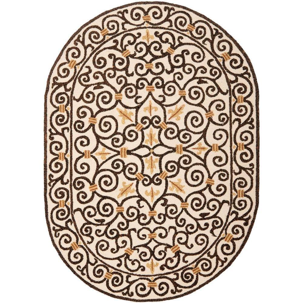 SAFAVIEH Chelsea Ivory/Dark Brown 5 ft. x 7 ft. Oval Border Area Rug 100% pure virgin wool pile, hand-hooked to a durable cotton backing. American Country and turn-of-the-century European designs. This collection is handmade in China exclusively for Safavieh. This is a great addition to your home whether in the country side or busy city. Color: Ivory/Dark Brown.