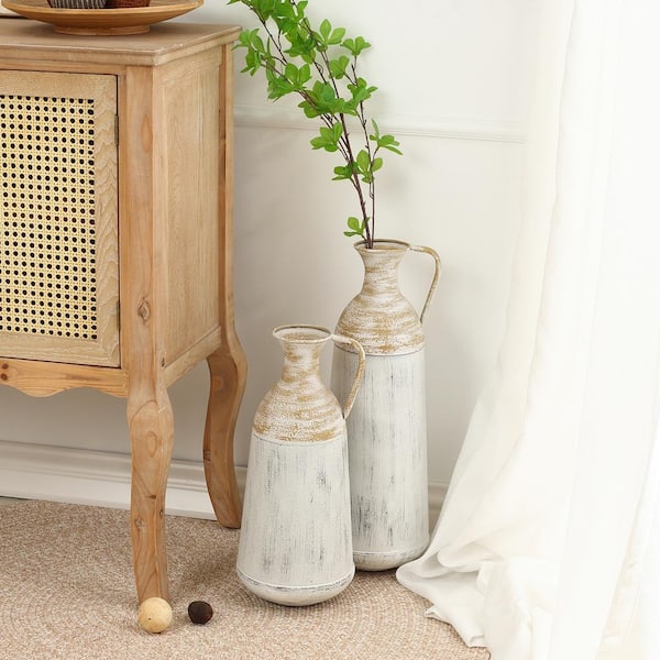https://images.thdstatic.com/productImages/c96487c6-edf6-4f86-9296-be8e21ec1209/svn/distressed-off-white-and-rustic-brown-luxenhome-vases-whd747-c3_600.jpg