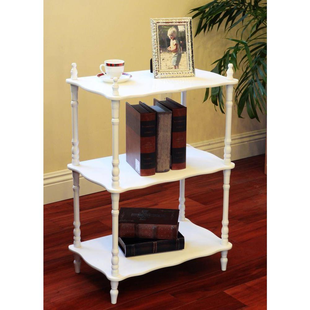 White freestanding decorative shelf holding books and decorative items on a wooden floor.