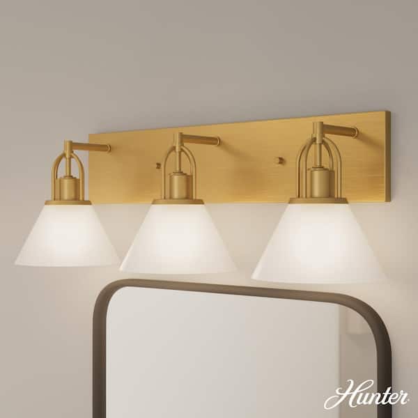 Hunter Carrington Isle 27.25 in. 3-Light Luxe Gold Vanity Light with Cased White Glass Shades