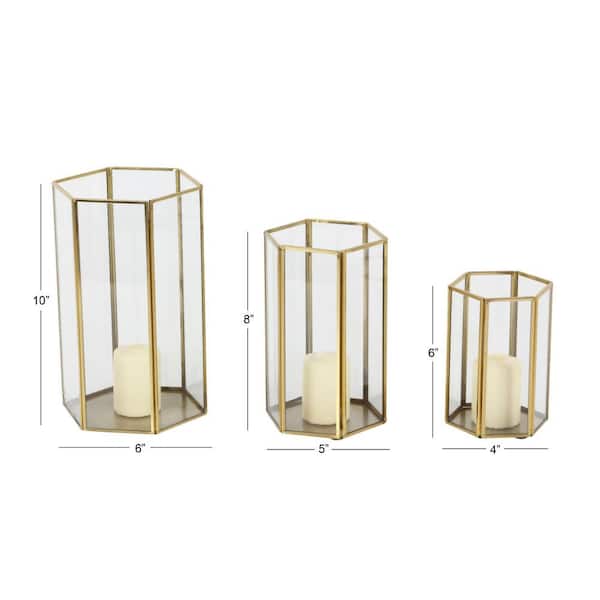 https://images.thdstatic.com/productImages/cbac5179-2353-4ec0-ae5f-0226bd29e504/svn/gold-cosmoliving-by-cosmopolitan-candle-holders-57378-77_600.jpg