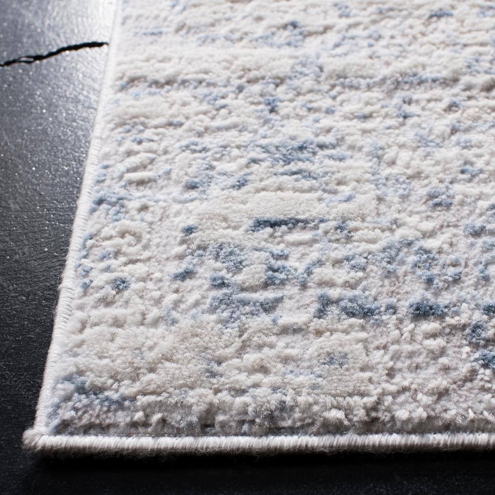 Ivory and Blue Abstract 8' x 10' Synthetic Area Rug