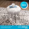 Faux fur ottoman stool with a small decorative item on top in a living room.