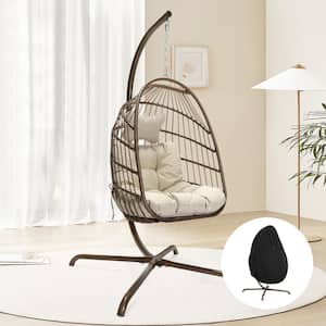 1 Person Foldable Brown Wicker Porch Swing Egg Chair with Gold Stand Beige Cushions and Chair Cover 350 lbs. Capacity