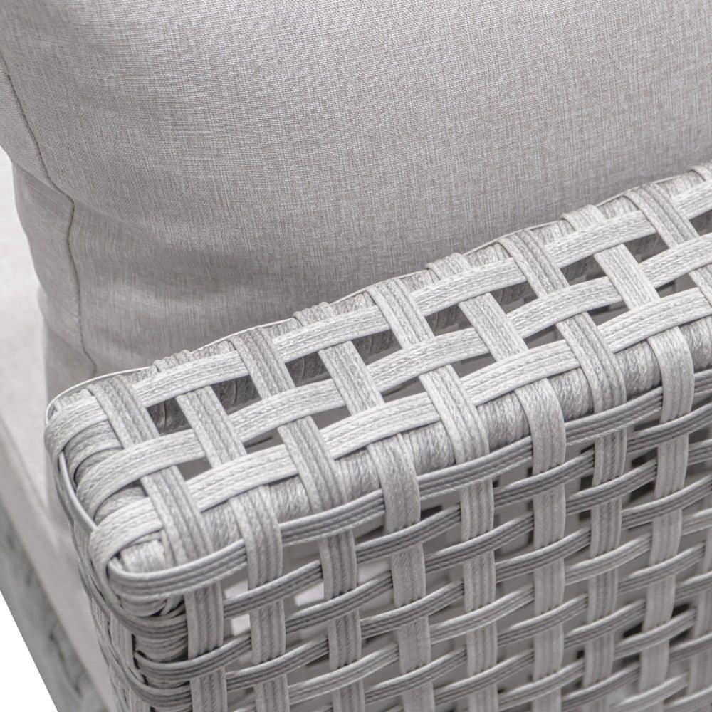 Extreme close-up of the gray woven rattan and cushion fabric.