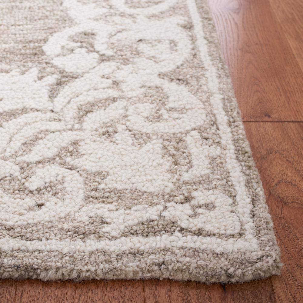 Handmade Ivory Abstract Tufted Wool Round Rug