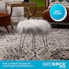 Stylish faux fur ottoman stool in a living room setting.