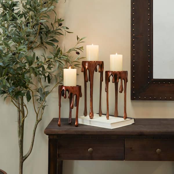Litton Lane Copper Aluminum Pillar Candle Holder with Dripping Melting Designed Legs (Set of 3)