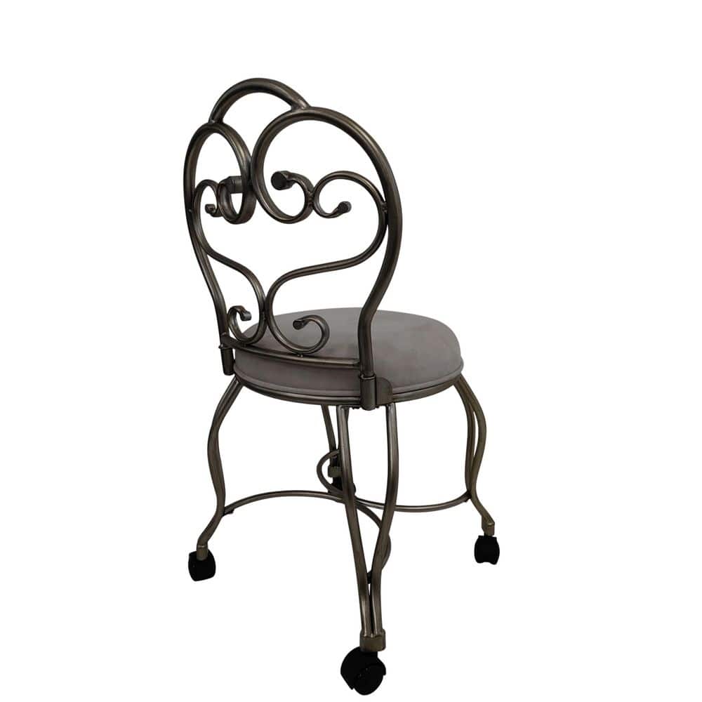 Three-quarter view of a Victorian gilded silver vanity stool with a grey seat.