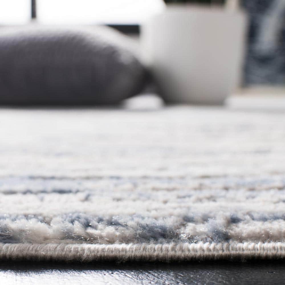 Ivory and Blue Abstract Synthetic Area Rug, 3' x 5'